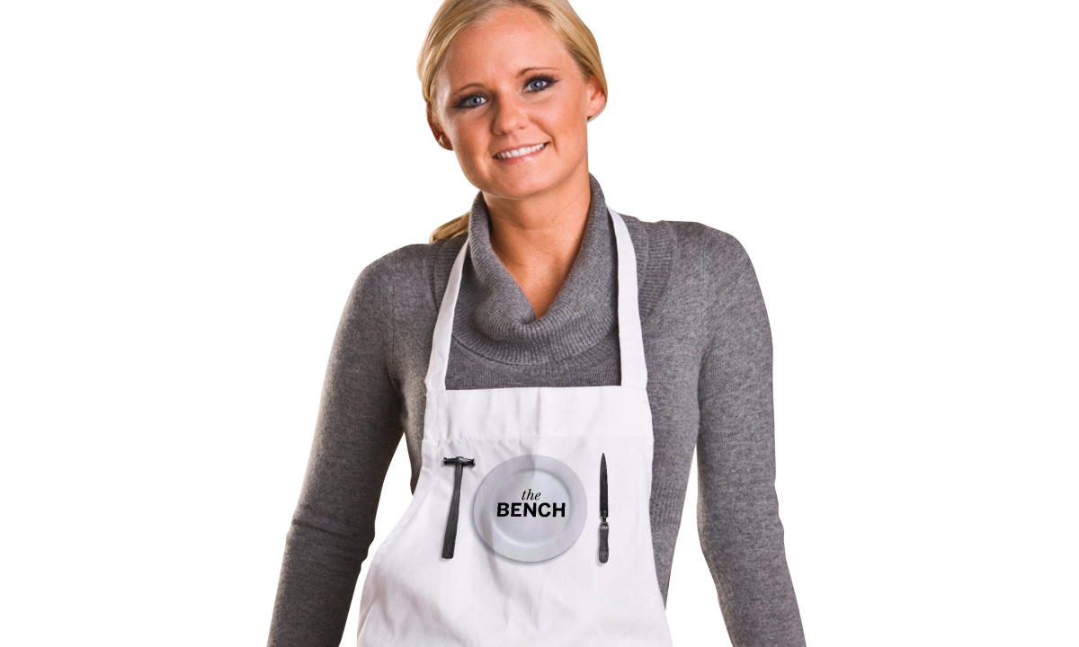 By Dana Robertson Creative Director and Founder of Neon. The Bench café brand identity, apron. As part of Neon's wider involvement in this ground-breaking development, we were asked to name and create the brand identity for The Goldsmiths’ Centre’s new café. The aim was to provide a friendly and inspiring environment in which members of the silversmithing trade, patrons, partners and the visiting public could relax and rub shoulders, helping to forge a flourishing creative community. The name we came up with — The Bench — was a reference to both heritage (the silversmith’s classic workbench) and the informal ambience of the café itself. The Bench café brand identity also celebrated silversmithing heritage, replacing cutlery with classic silversmithing tools – selected from world renowned silversmith Grant MacDonald’s studio. The Bench café brand identity was rolled out on signage, uniforms, crockery, literature, and environmental graphics. – Idea, art direction and design by Neon Design & Branding Consultancy www.neon-creative.com