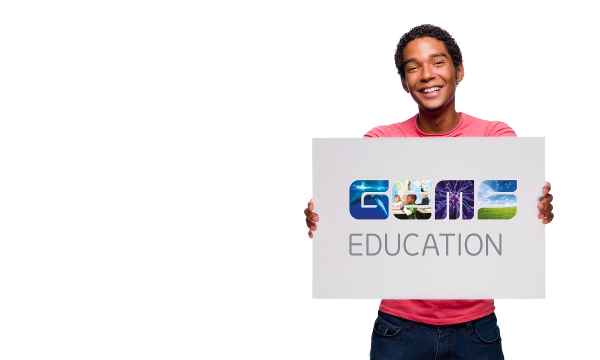Branding by Neon - GEMS Education - GEMS Education logo designed by Dana Robertson being held up by student